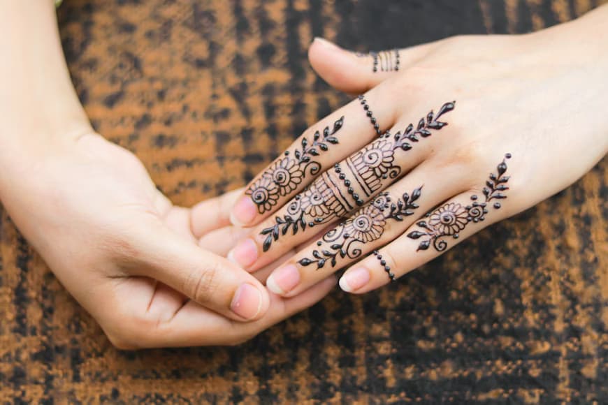 Henna artist applying paste with precision